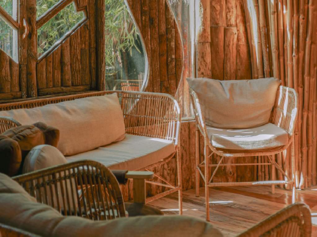 Lounge seating against warm bamboo-clad walls and organic windows